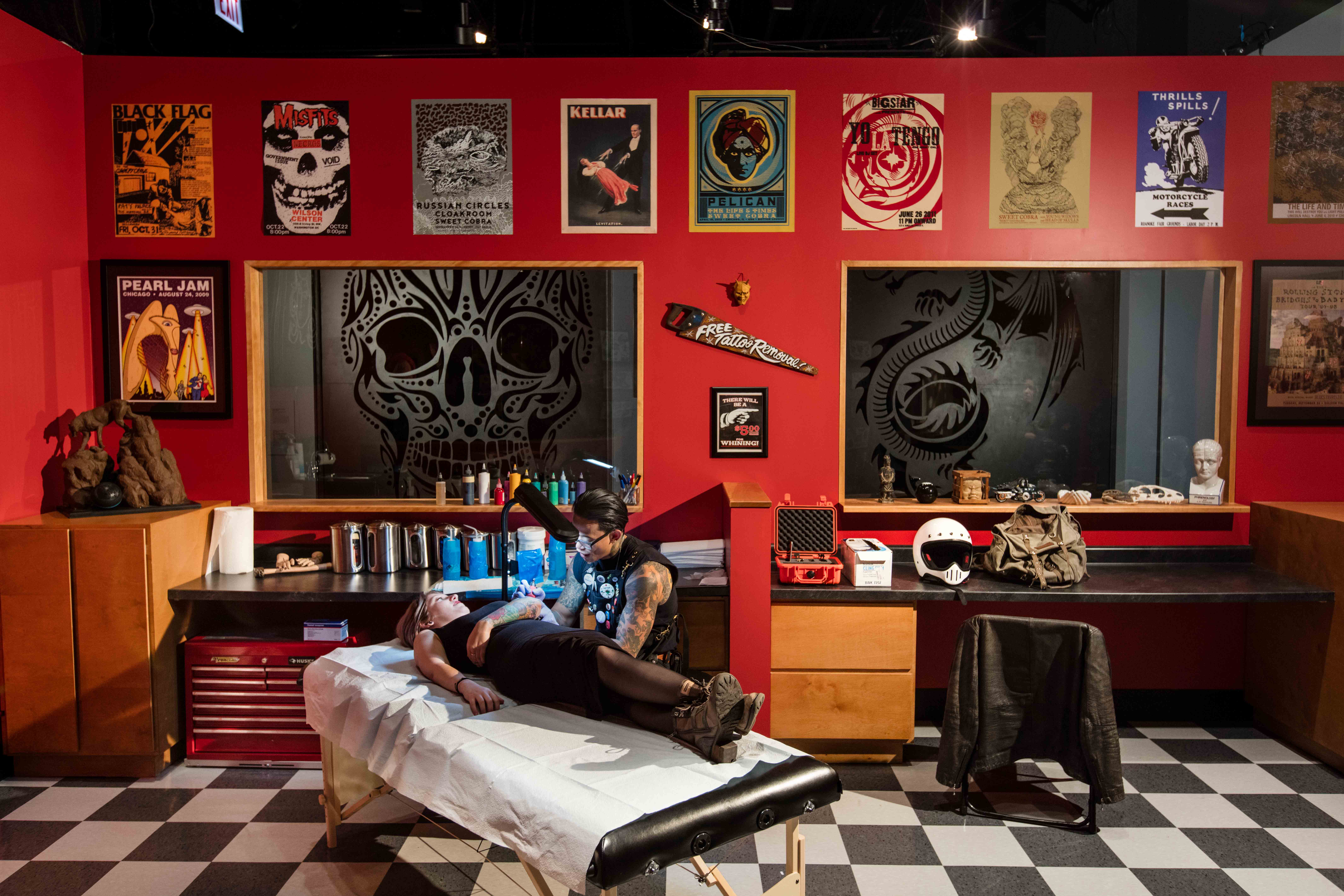 Tattoo artist working on a detailed custom tattoo