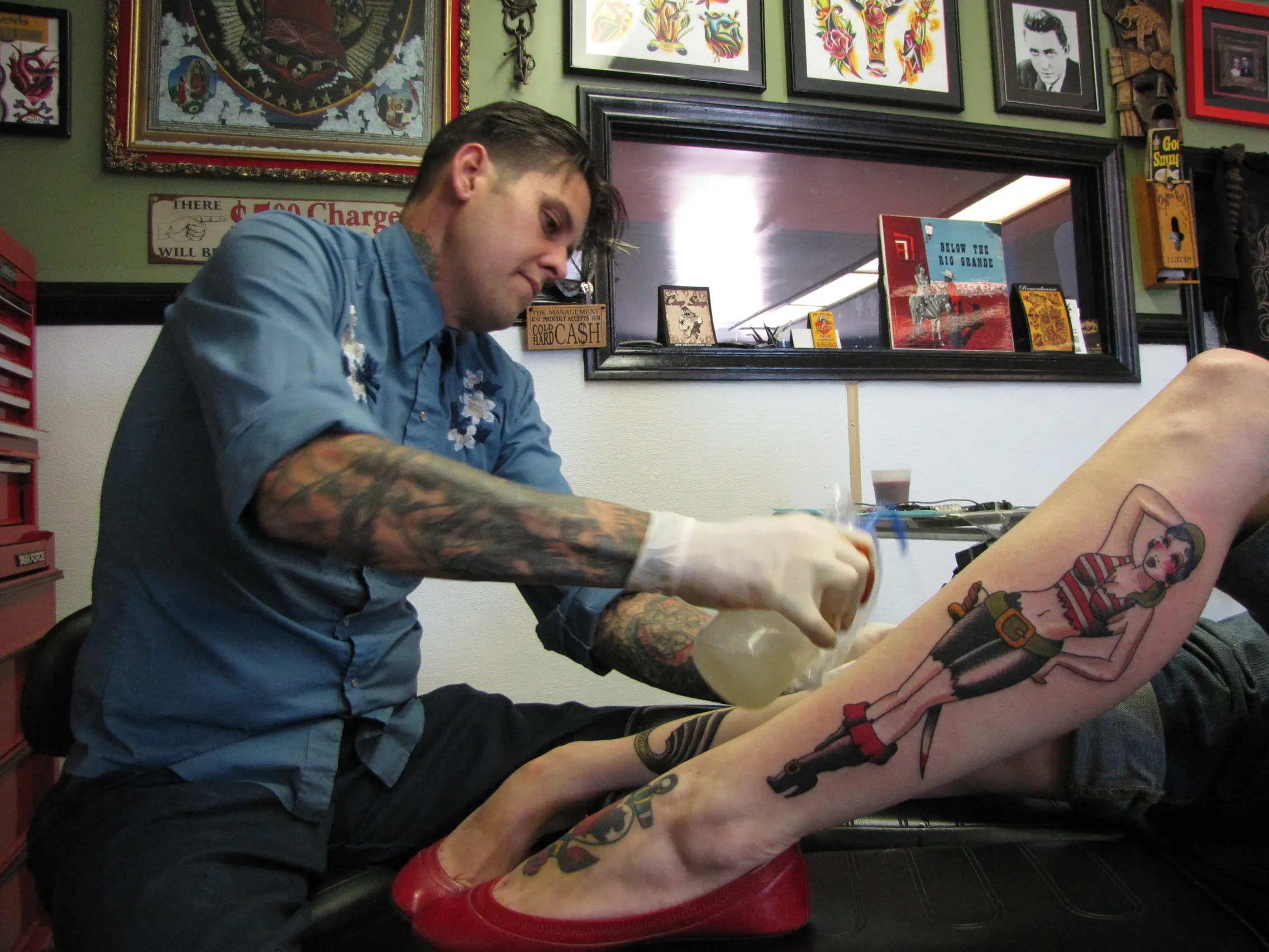 Illustrated tattoo studio entrance with artwork on display
