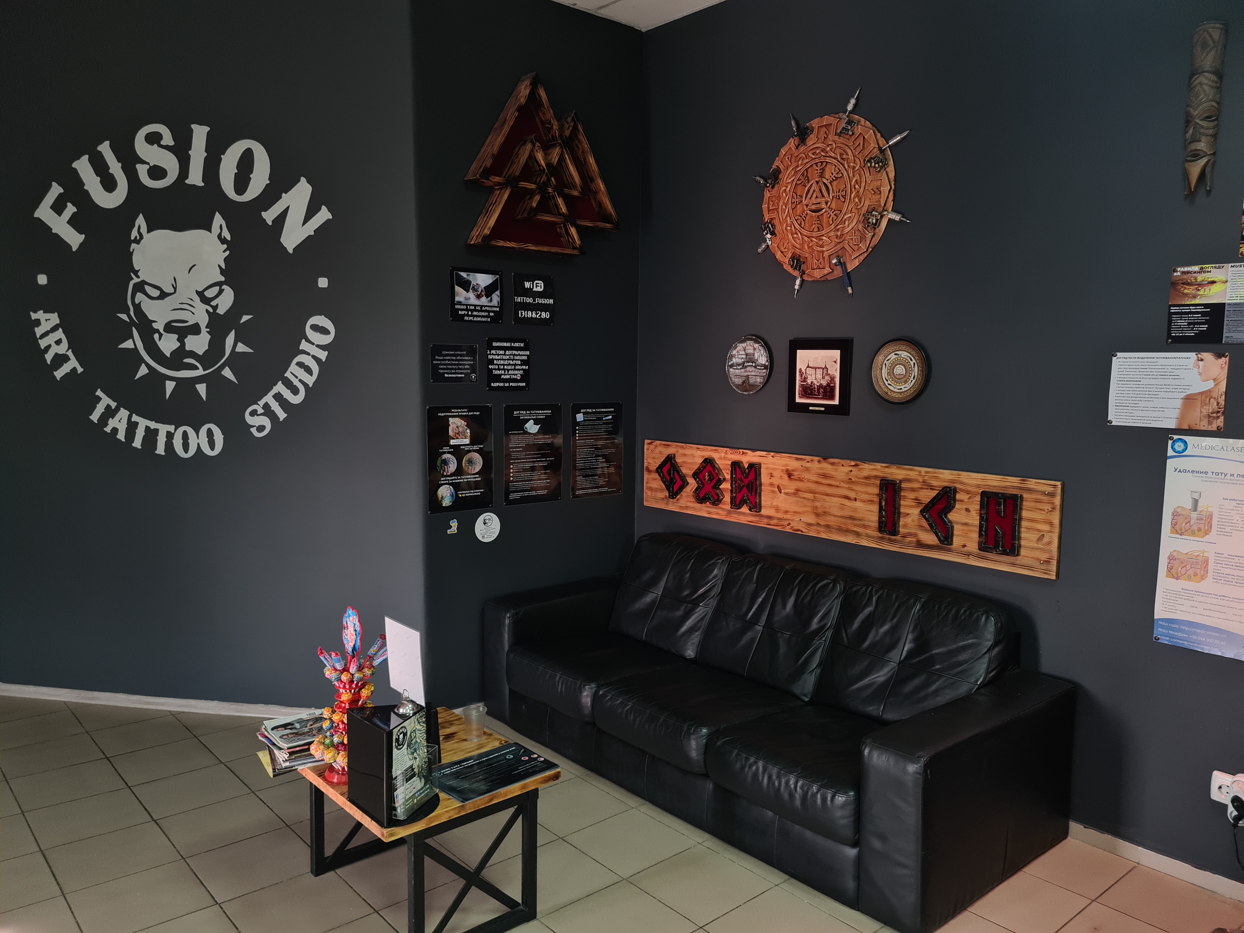 Tattoo artist creating detailed custom artwork in a studio